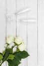 Top view of three White roses and two champagne glasses on old white wooden table love concept Royalty Free Stock Photo
