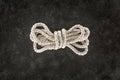 top view of tied white nautical rope on dark