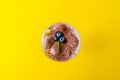 Top view of tiramisu dessert with mint and strawberries in a glass on yellow background