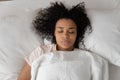 Top view of tired black girl sleeping in white bed Royalty Free Stock Photo