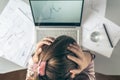 Top view. Tired business woman with headache at office with glass of water and pill on the background of graphics and charts print