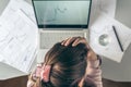 Top view. Tired business woman with headache at office with glass of water and pill on the background of graphics and charts print