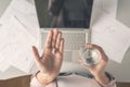 Top view. Tired business woman holding a headache pill on the workplace with glass of water on the background of graphics and cha