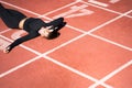 Top view of tired fit woman resting after workout or running, holding a bottle of water, taking a break during training Royalty Free Stock Photo