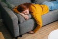 Top view of tired peaceful beautiful woman sleeping on cozy couch in living room, lying on stomach. Exhausted young Royalty Free Stock Photo