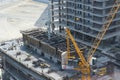 Top view to building construction site with group of builders on roof. Modern skyscraper building construction in UAE