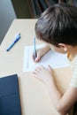Top view to cute boy doing his homework Royalty Free Stock Photo