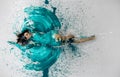 Top view to expressive sexy woman lies elegant on the floor in turquoise blue color abstractly painted bodypainting woman on the