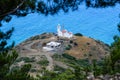 Top view to lighthouse, Turkey. Deep blue sea, lighthouse, trees. Royalty Free Stock Photo