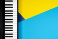 Top view to piano on yellow and blue background. Music learning concept. Top view Royalty Free Stock Photo