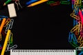 Top view to school supplies background with clips, pencil, eraser and lined page of notpad