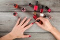 Top view to woman hands, applying coat of red nail varnish on he Royalty Free Stock Photo