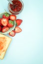 Top view of toast strawberries and jam on isolated pastel background with copy space