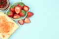 Top view of toast strawberries and jam on isolated pastel background with copy space