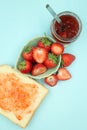 Top view of toast strawberries and jam on isolated pastel background