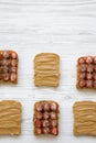 Top view, toasts with peanut butter, strawberries and chia seeds over white wooden background. Royalty Free Stock Photo