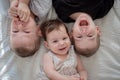 Top view of toddler brothers and sister laying in bed together. Lifestyle family concept Royalty Free Stock Photo