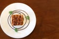 Top view of toffee cake in white plate on wooden table look delicious Royalty Free Stock Photo