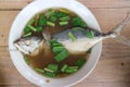 Top view Tom Yum Mackerel food, put coriander in a bowl of Thai food concept dishes