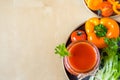 Top view tomato smoothie in a glass jar with the ingredients for its preparation. Fresh tomatoes, carrots, bell peppers and