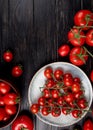 top view of tomatoes in plate and other ones on wooden background Royalty Free Stock Photo