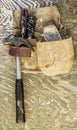 Old Construction tools belt bag on a piece of  plywood Royalty Free Stock Photo