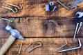 Top view tools and fasteners lie on wooden background.copyspace for text