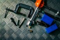 Top view of tools on industrial metal checker plate. Metal checkerplate for anti skid. Nut, bolts, and hex key on metal sheet Royalty Free Stock Photo