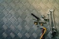 Top view of tools on industrial metal checker plate. Metal checkerplate for anti skid. Nut, bolts, and hex key on metal sheet Royalty Free Stock Photo