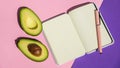 Top view. Top view An empty notepad and sliced avocado on a pink background Top view. Royalty Free Stock Photo