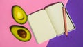 Top view. Top view An empty notepad and sliced avocado on a pink background Top view. Royalty Free Stock Photo