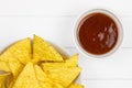 Top-view of tortilla chips with salsa sauce