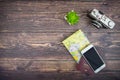 Top view of tourist accessories with film cameras, maps, passports and smartphones. On the old wooden background. With copy space