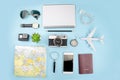 Top view of tourist accessories with film cameras, maps, passports, watches, compasses, sunglasses, earphone and smartphones. On a Royalty Free Stock Photo