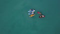 Top view of tourists on sea with SUP-boards. Clip. Beautiful clear sea with people floating on boards engaged in sup