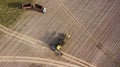 Top view of the tractor and freight car in the field of sugar beet. Aerial view