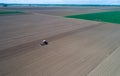 Top view of tractor harrowing field Royalty Free Stock Photo