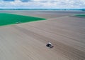 Top view of tractor harrowing field Royalty Free Stock Photo