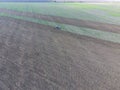 Top view of the tractor that plows the field. disking the soil. Soil cultivation after harvest Royalty Free Stock Photo