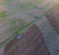 Top view of the tractor that plows the field. disking the soil. Soil cultivation after harvest Royalty Free Stock Photo