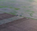 Top view of the tractor that plows the field. disking the soil. Soil cultivation after harvest Royalty Free Stock Photo