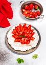 Top view of traditional Australian dessert Pavlova cake with strawberries and meringue.