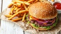 Top view of traditional burger and french fries on wooden table with space for text Royalty Free Stock Photo