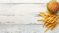 Top view of traditional burger and french fries on wooden table with space for text Royalty Free Stock Photo