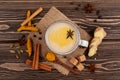 Top view on traditional indian drink masala chai tea with milk and spices as cinnamon stick, green cardamom, anise star and ginger Royalty Free Stock Photo