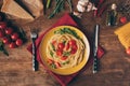 Top view of traditional italian pasta with tomatoes and arugula in plate on wooden table Royalty Free Stock Photo