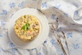 Rustic vegetable Olivier salad served in plate on white and blue textile with lavender on background Royalty Free Stock Photo