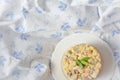 Ukrainian Rustic vegetable Olivier salad served in plate on white and blue textile background Royalty Free Stock Photo