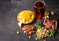 Top view of traditional snacks and dark beer on a gray background. Peanuts, pistachios, meat with a glass of beer. Cold Royalty Free Stock Photo