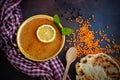 Top view of traditional turkish lentil soup with lemon and mint in ceramic bowl, heap of red lentils, black peppercorns, flatbread